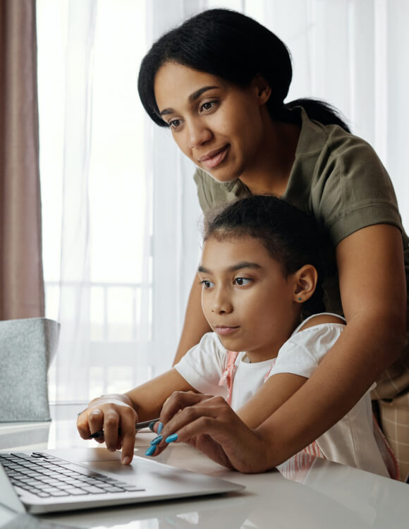Mother and child looking at a laptop computer together