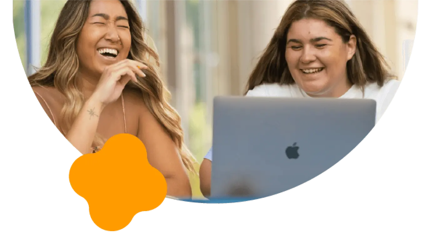 Photo of two girls sitting at a laptop
