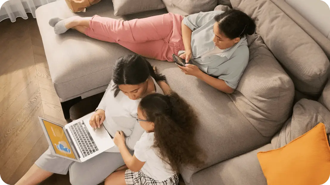 Photo of a family looking at a laptop