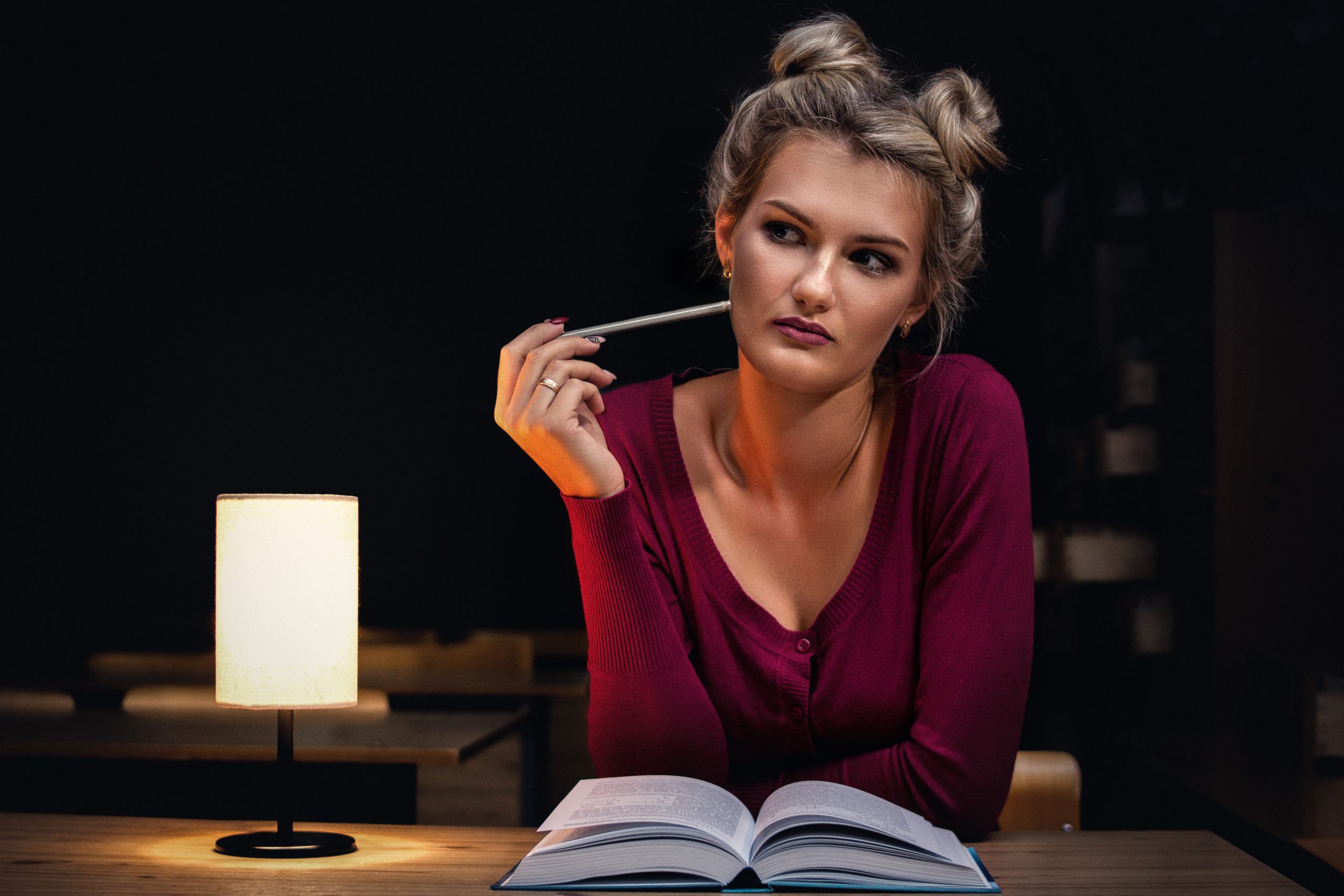 woman thinking in front of book
