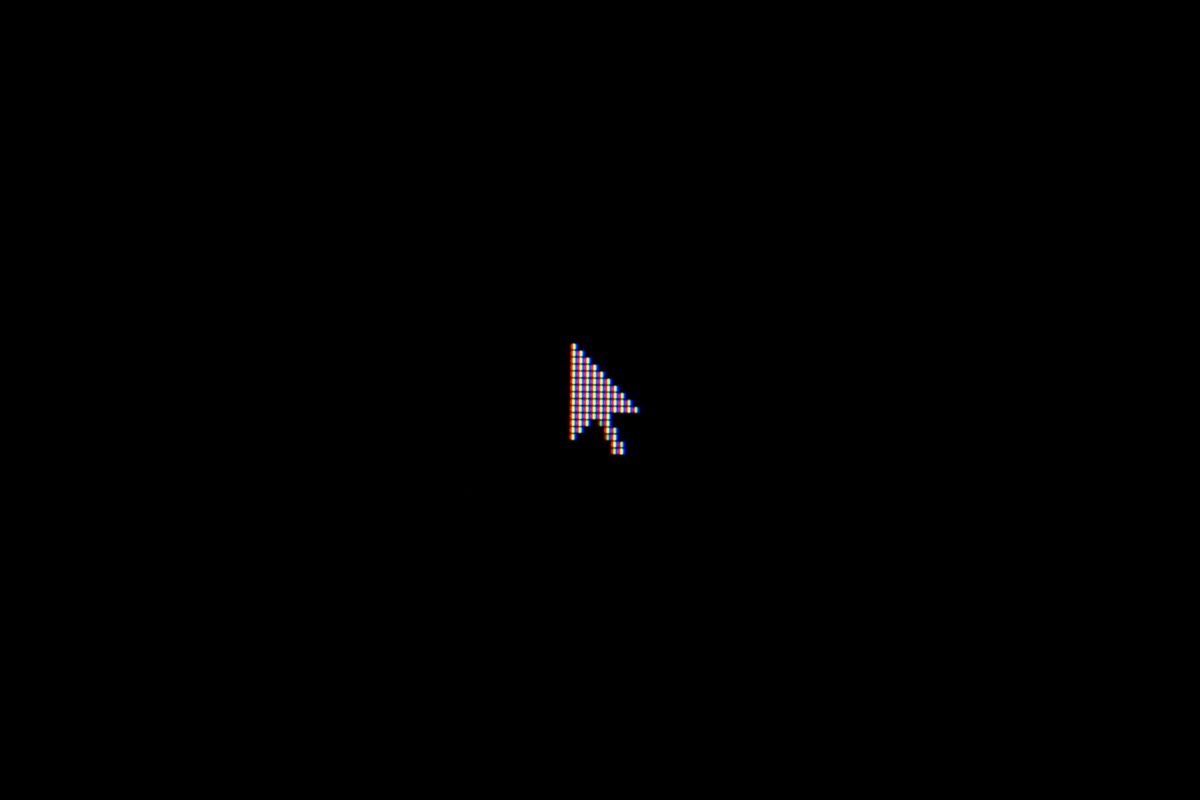 A black background with a white pixelated cursor in the center.