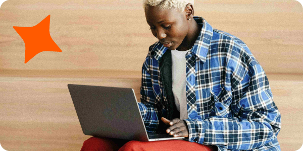 A young black woman working on a laptop